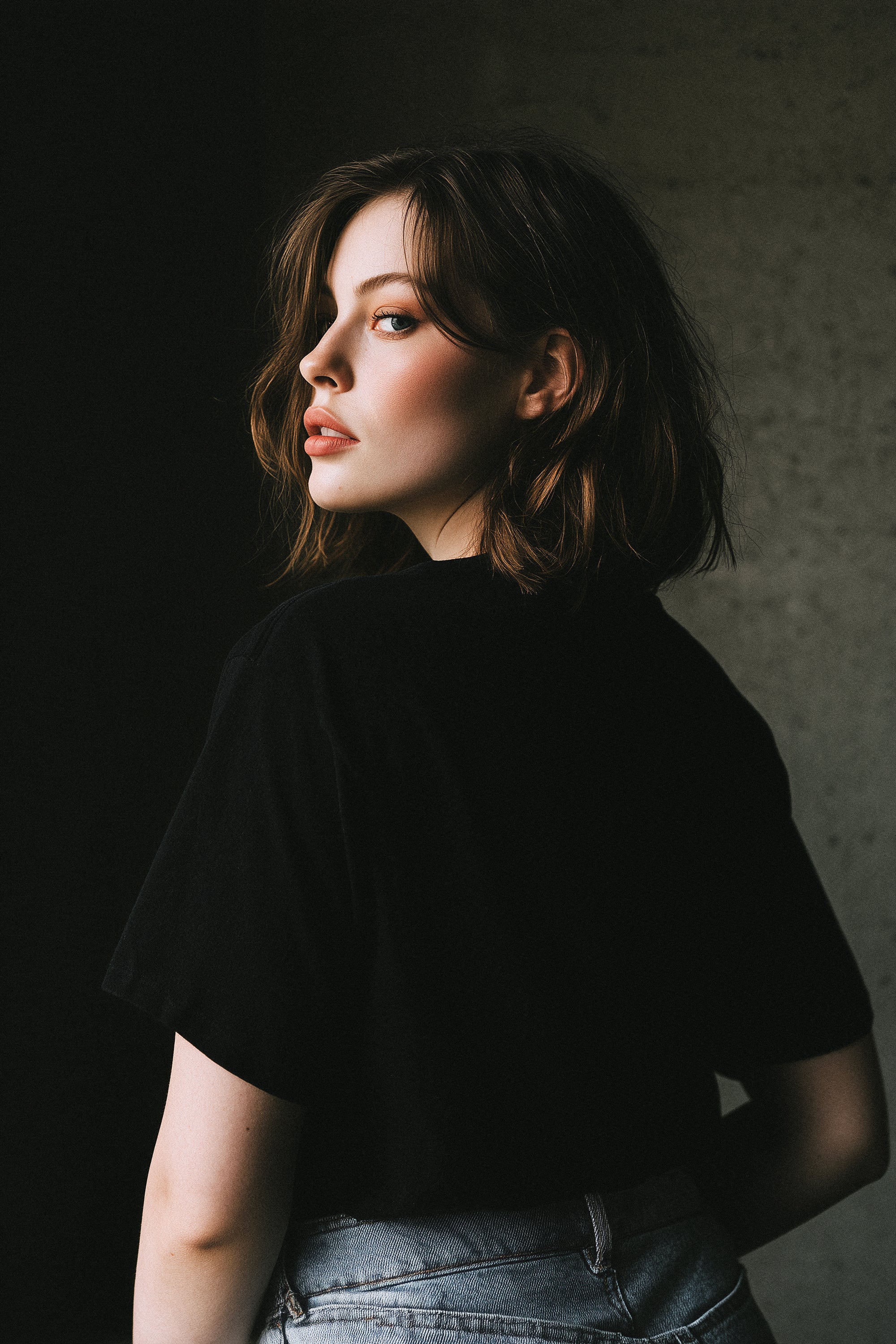 Woman wearing a black shirt against a dark background