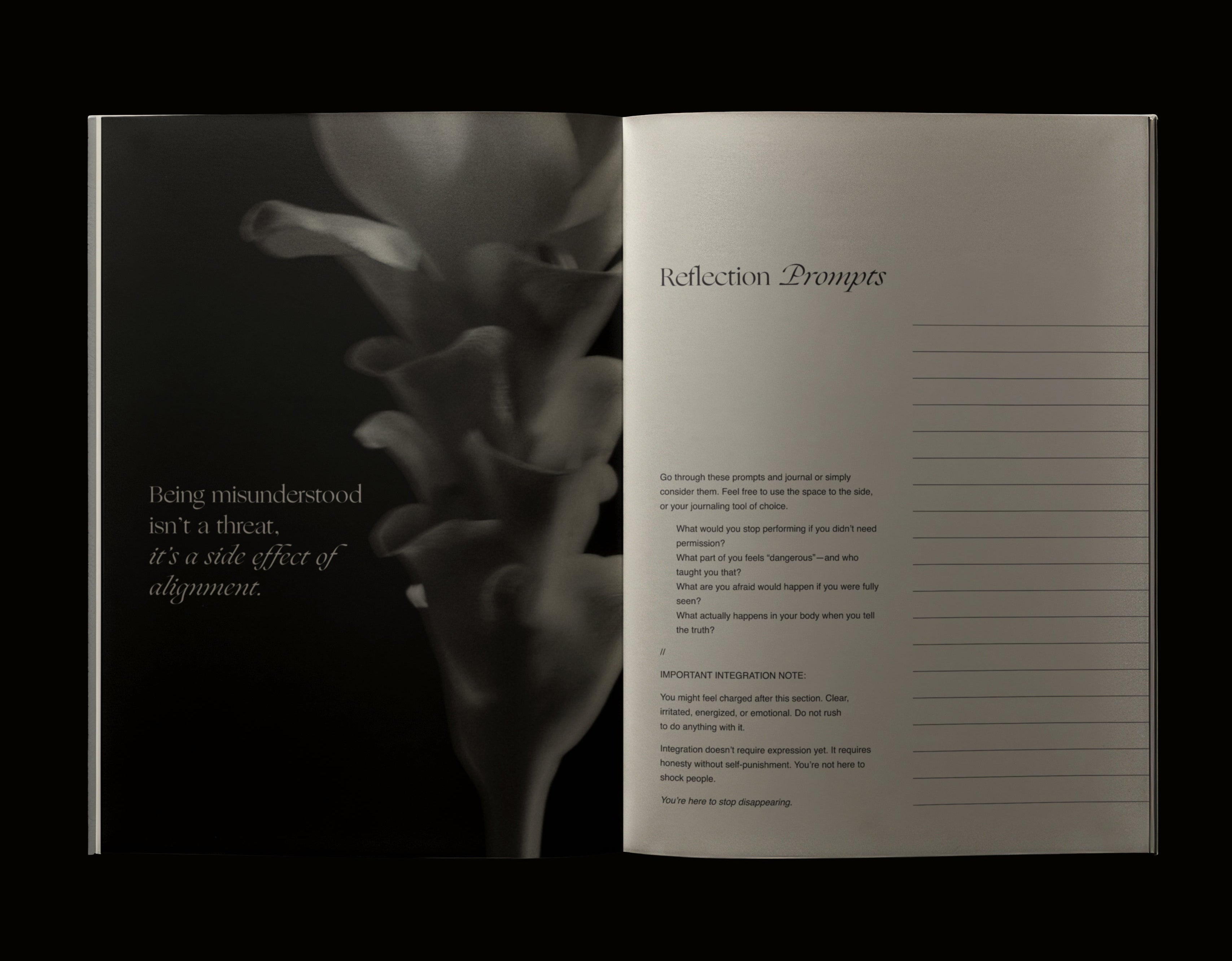 Open book with a flower illustration on one page and text on the other, against a black background.