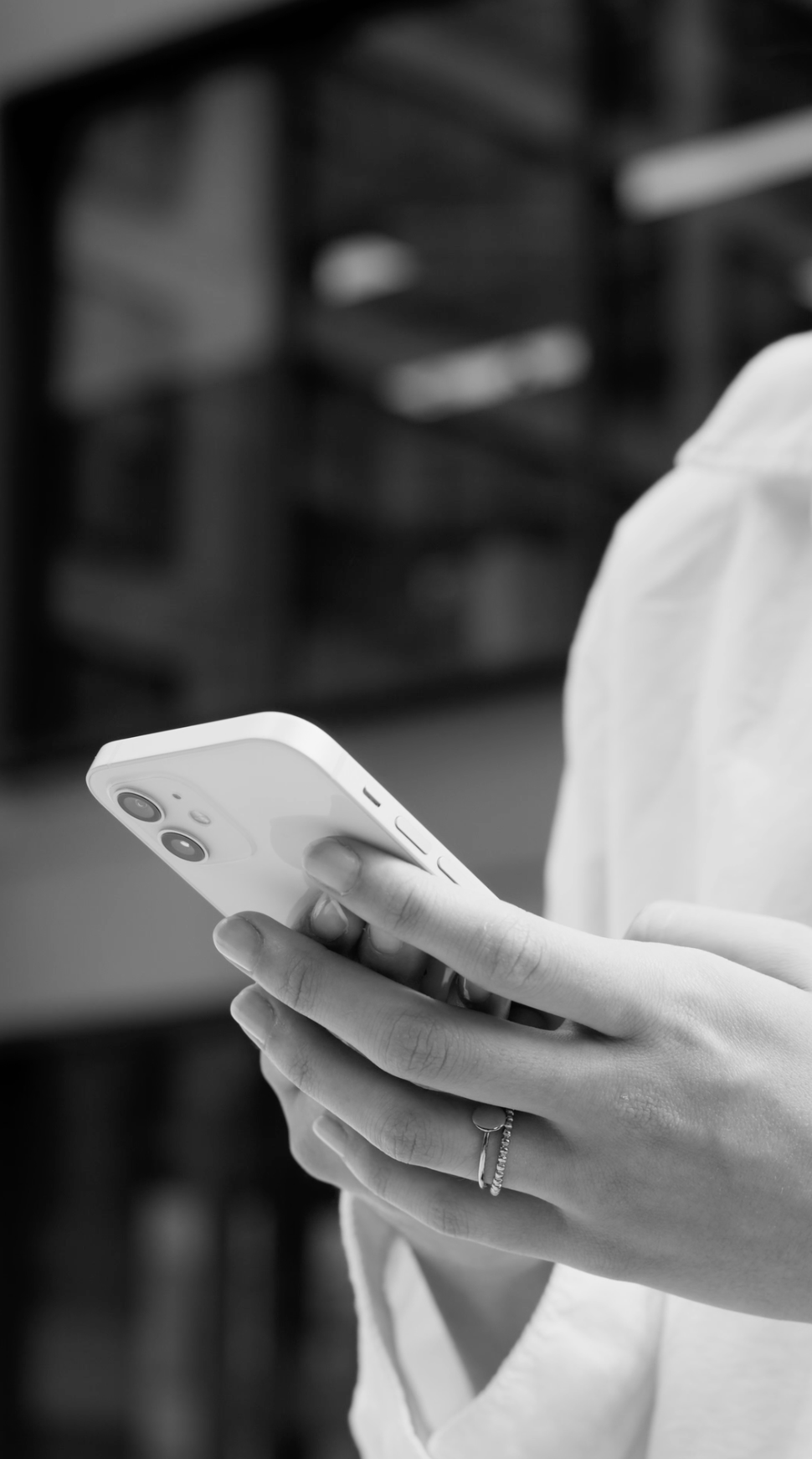 Person holding a smartphone with a blurred background